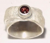Broad silver ring with a tourmaline.